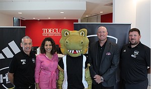 Pictured (L to R): HTX Soccer Director of Operations Simon Boddison,TDECU SVP Marketing & Brand Laura Whitley, HTX Soccer mascot HT-Rex,TDECU Chief Growth Officer Josh Brian, and HTX Soccer Director of Communications & Events Stuart Taylor