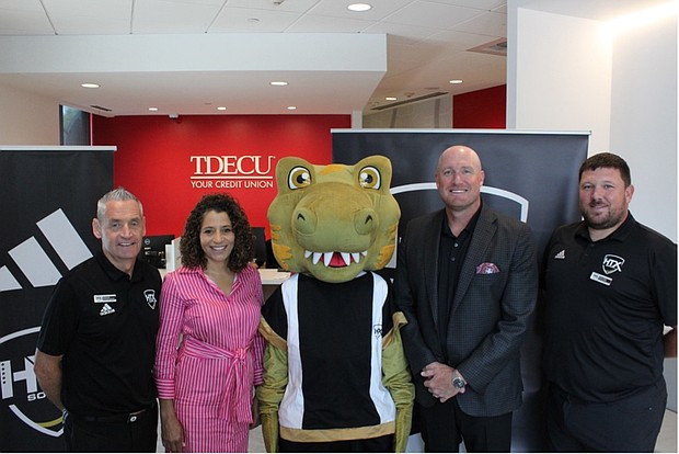 Pictured (L to R): HTX Soccer Director of Operations Simon Boddison,TDECU SVP Marketing & Brand Laura Whitley, HTX Soccer mascot HT-Rex,TDECU Chief Growth Officer Josh Brian, and HTX Soccer Director of Communications & Events Stuart Taylor