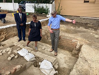 From left, Reginald F. Davis, pastor of First Baptist Church, Connie Matthews Harshaw, a member of First Baptist and Jack Gary, Colonial Williamsburg’s director of archaeology, stand at the foundation of one the oldest Black churches in the U.S. in 2021, in Williamsburg.