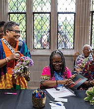 Richmond Free Press photojournalist Regina H. Boone speaks during the event, with photojournalist Sandra Sellars and Richmond Free Press Vice President of Production April Coleman listening. Both shows run through July 12.