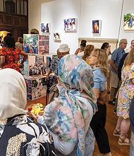 Guests mingle at the Juneteenth opening of “(re)Framing Protest (NOW): Design + Hope” and “Echoes of Us” at the Branch Museum of Architecture and Design. The exhibitions feature work by more than 15 Black artists from Virginia and explore national conversations on race, protest and cultural memory through art and design.