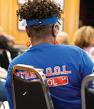 Supporters of Armstrong High School listen during a discussion about whether to change the school’s name.