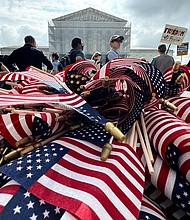 American flags are seen during a protest outside the US Supreme Court over President Donald Trump's move to end birthright citizenship as the court hears arguments over the order in Washington, DC, on May 15.
Mandatory Credit:	Drew Angerer/AFP/Getty Images via CNN Newsource
