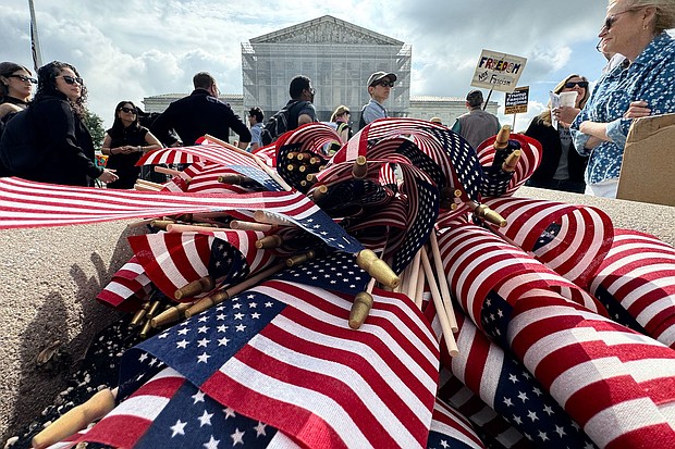 American flags are seen during a protest outside the US Supreme Court over President Donald Trump's move to end birthright citizenship as the court hears arguments over the order in Washington, DC, on May 15.
Mandatory Credit:	Drew Angerer/AFP/Getty Images via CNN Newsource