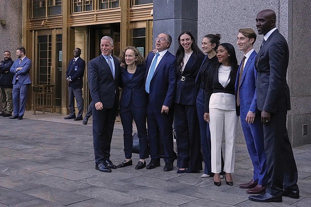 Defense attorneys for Sean “Diddy” Combs, including from left, Brian Steel, Alexandra Shapiro, Marc Agnifilo and Teny Garagos, Anna Estevao, Nicole Westmoreland, Jason Driscoll and Xavier Donaldson, far right, line up for a group photo outside Manhattan federal court after Sean “Diddy” Combs was denied bail after being convicted of prostitution-related offenses but acquitted of sex trafficking and racketeering charges, Wednesday, July 2 in New York.