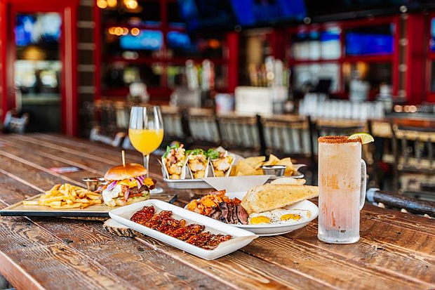 Avalanche Food Group Founders Ricky Rosa, Joe Rosa (left) and John Rosa (center) treated teachers and their families to meals at Twin Peaks and Bread Zeppelin before the 2024 grant check presentations.

Photo: Avalanche Food Group