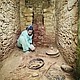 Diane Z. Chase in the tomb of Te K’ab Chaak with vessels in the foreground and jadeite mask to the left and the south wall niche./