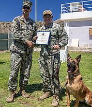 Master-at-Arms 2nd Class Kelton Wood at Souda Bay, reenlisted by Lt. j.g. Matthew Whaley, security officer
