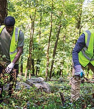 Members of the Ahmadiyya Muslim Community gathered Thursday, July 3, for a day of service as part of Jalsa Cares, a lead-in to the group’s 75th annual Jalsa Salana convention held July 4-6 in Richmond. Kaleem Wali, left, and Amjad Mahmood Khan, right, began the day at
East End Cemetery, clearing overgrown weeds and invasive plants to
reveal long-neglected gravesites.