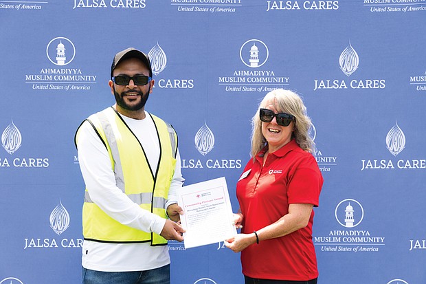 American Red Cross Community Volunteer Leader Christy Carneal presents Umer Sindhu and the Ahmadiyya Muslim Youth Association Richmond Chapter with a Community Partner Award.