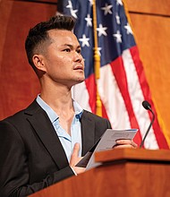 Burhan Hussaini, originally from Afghanistan, leads the Pledge of Allegiance during a naturalization ceremony Friday, July 4, at the Virginia Museum of History & Culture, where he and dozens of others received their U.S. citizenship.