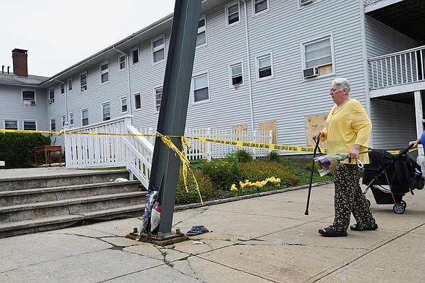 Kathleen Banuelos of Fall River brings a bouquet of flowers to the Gabriel House Assisted Living Facility after a deadly fire in Fall River, Massachusetts Monday.
Mandatory Credit:	Ken McGagh/Reuters via CNN Newsource