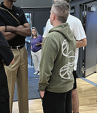 NBA Hall of Famer and Harrisonburg native Ralph Sampson talks with team coaches during the games.