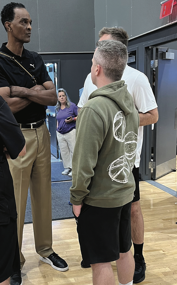NBA Hall of Famer and Harrisonburg native Ralph Sampson talks with team coaches during the games.