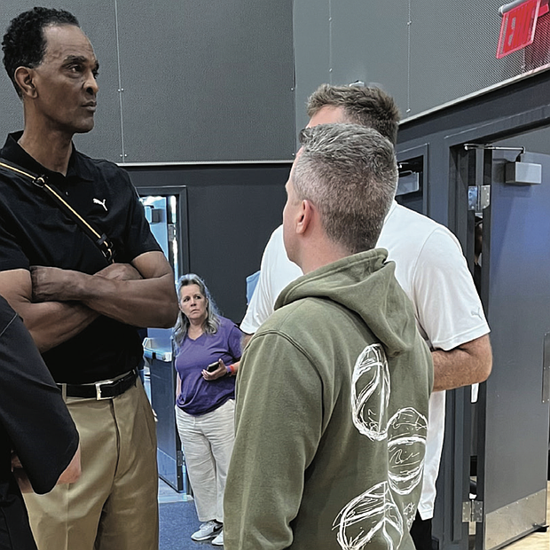 NBA Hall of Famer and Harrisonburg native Ralph Sampson talks with team coaches during the games.