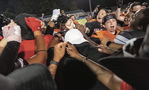 Coaches and players celebrate after the game.