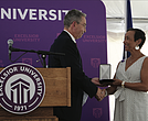 Excelsior University President David Schejbal presents the university’s President’s Medal posthumously to Lt. Gen. Arthur J. Gregg, accepting on his behalf is his daughter, Alicia Collier.