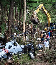 First responders carry out search and rescue operations near the Guadalupe River on July 7 after a flash flood swept through the area in Ingram, Texas.
Mandatory Credit:	Eli Hartman/AP via CNN Newsource