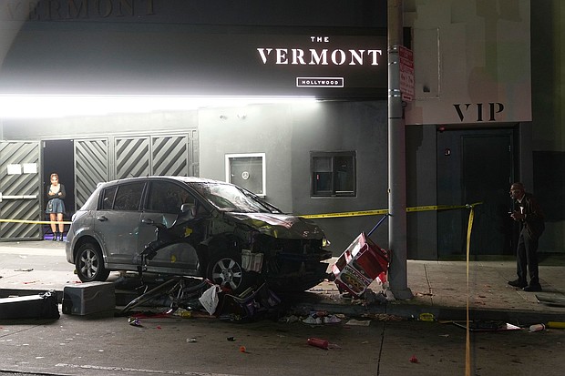 A vehicle sits on the sidewalk after ramming into a crowd of people waiting to enter a nightclub along a busy boulevard in Los Angeles on July 19, injuring several people.
Mandatory Credit:	Damian Dovarganes/AP via CNN Newsource