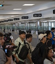 Travelers at Dulles International Airport in Virginia are pictured during a media event related to incoming foreign nationals on June 29. The United States will require international visitors to pay a new “visa integrity fee” of at least $250.
Mandatory Credit:	Celal Gunes/Anadolu Agency/Getty Images via CNN Newsource