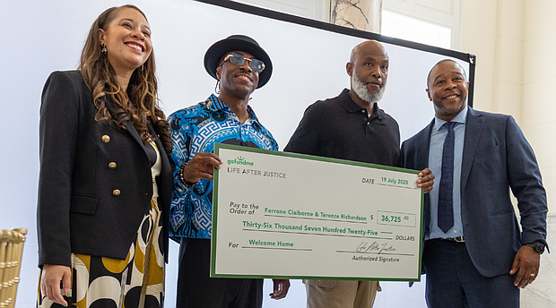 Joi Adams, executive director of Life After Justice, Terence Richardson, Ferrone Claiborne and Life After Justice Co-Founder Jarrett Adams celebrate during a “Celebration of Freedom” brunch Saturday, July 19, when the organization presented the two men with a check.