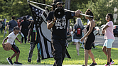 JaPharii Jones, president of BLM 757, leads chants with a megaphone on the median of Monument Avenue during the “Good Trouble Lives On” protest Thursday, July 17. Organized by 50501 Virginia, RVA Indivisible, BLM RVA and other groups, the demonstration stretched three miles from Lombardy Street to Willow Lawn. The event marked the anniversary of civil rights leader John Lewis’ death and his call to get into “good trouble” to protect American democracy.