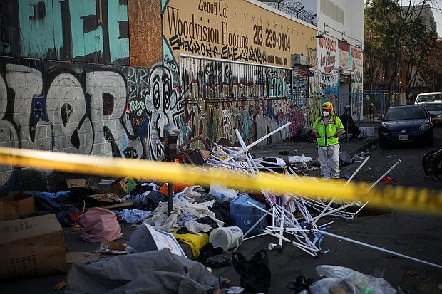 A worker stands on a corner during a street cleaning operation in Skid Row Los Angeles, California, U.S., December 9, 2024.
Mandatory Credit:	Daniel Cole/Reuters via CNN Newsource