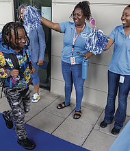 School staff cheered Shayne Williams on his first day of fifth grade at Oak Grove-Bellemeade Elementary School on Monday, July 21. Oak Grove-Bellemeade is one of four Richmond Public Schools operating on a 200-day calendar. Richmond Public Schools launched the extended-year pilot in the 2023-24 school year at Fairfield Court and Cardinal elementary schools to address long-standing equity and achievement gaps worsened by the pandemic.
