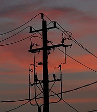 The sun rises behind power cables and telephone lines hang from a utility pole in Houston, Texas, on July 1.
Mandatory Credit:	Aaron M. Sprecher/AP via CNN Newsource
