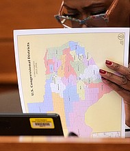 Texas state Rep. Jolanda "Jo" Jones looks through US Congressional District maps during a redistricting hearing at the Texas Capitol on July 24 in Austin, Texas.
Mandatory Credit:	Eric Gay/AP via CNN Newsource