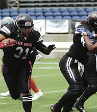 Ja’Mesha “Jam” Worthington (31) of Richmond’s undefeated Black Widows women’s tackle football team runs the ball during the national championship game against the Oklahoma Rage on Saturday, July 26.