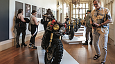 A visitor checks out a custom motorcycle on display at the “Ruined + Refined” exhibition, featuring unique builds and Vespa scooters. The exhibitions continue through Aug. 31.