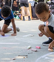 Brothers Alvin, 6, and Ashton, 3, Shelton draw with chalk as the music plays at 804 Day.