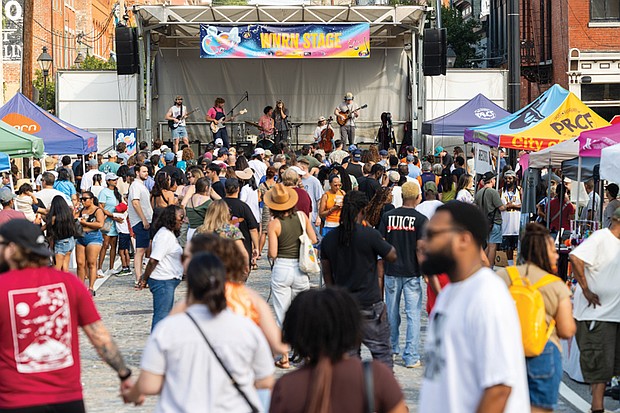 Richmonders gathered in Shockoe Bottom on Saturday, Aug. 2, to celebrate 804 Day. a block party–style festival featuring live music across multiple stages, local vendors, food, drinks and showcases of area nonprofits. In this photo, rock band Bucko performs on the WNRN stage.