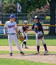 Aiki Uchida, of Saitama Japan Little League and Andrew McKetta of Richmond Little League chat on the field Monday, Aug. 4 during interleague games held as part of the Richmond Little League Sister City Baseball Exchange.