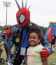Mariyah Martin, 6, poses for a photo with Spider-Punk during the event.