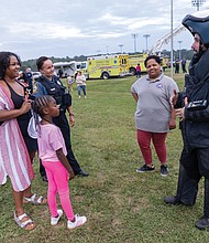 Erin Carter and her daughter, Emree, learn about the bomb suit used by Henrico Police Department.