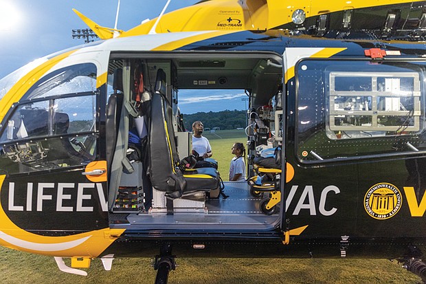 Ron Wright and his 8-year-old daughter, Jordan, learn about VCU’s LifeEvac helicopter and emergency response operations.