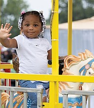 A’Layla Hunter, 2, enjoys a carousel ride during the 42nd Annual National Night Out at Dorey Park on Tuesday, Aug. 5. The event, organized by Hope Givers USA and Speaking Spirit Ministries, drew an estimated 17,000 people. See story for more photos.