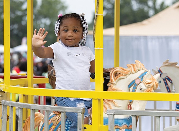 A’Layla Hunter, 2, enjoys a carousel ride during the 42nd Annual National Night Out at Dorey Park on Tuesday, Aug. 5. The event, organized by Hope Givers USA and Speaking Spirit Ministries, drew an estimated 17,000 people. See story for more photos.