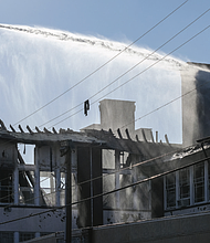 Firefighters at William Fox Elementary School on Feb.12, 2022, the day after a 3-alarm fire.