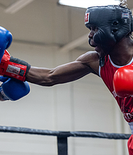 Kamaal Brown, fighting out of the red corner, faces Elliot Axeiman in bout five of the elite male division during the 5th Annual Gloves Over Guns boxing match at Varina High School on Saturday, Aug. 2.