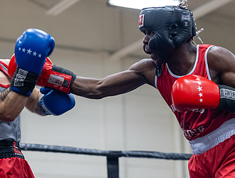 Kamaal Brown, fighting out of the red corner, faces Elliot Axeiman in bout five of the elite male division during the 5th Annual Gloves Over Guns boxing match at Varina High School on Saturday, Aug. 2.