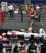 Noah Ricketts, in the blue corner, takes on Alan Reyes in bout eight of the junior male division.