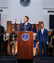 Gov. Glenn Youngkin, flanked by then-House Minority Leader Todd Gilbert, R-Shenandoah (left), and Attorney General Jason Miyares, speaks at a press conference on Thursday, Dec. 12, 2024, at the Patrick Henry Building in Richmond.