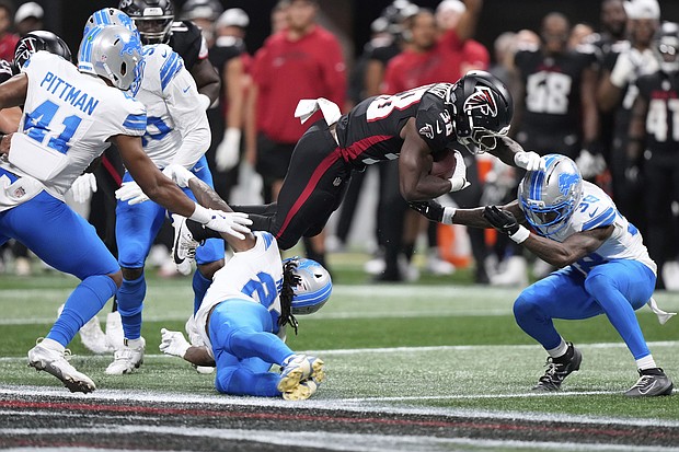 Detroit Lions safety Morice Norris  is hit in the helmet by Atlanta Falcons running back Nathan Carter (38) during the second half of an NFL preseason football game Friday.
Mandatory Credit:	Brynn Anderson/AP via CNN Newsource