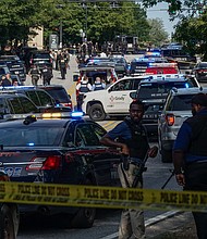 Law enforcement is seen near the CDC headquarters during an incident where a police officer was injured and later died at a hospital. The shooter was also dead.
Mandatory Credit:	Elijah Nouvelage/Getty Images via CNN Newsource