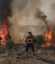 Firefighters battle a wildfire in Trancoso, Portugal, on August 11.
Mandatory Credit:	Patricia de Melo Moreira/AFP/Getty Images via CNN Newsource