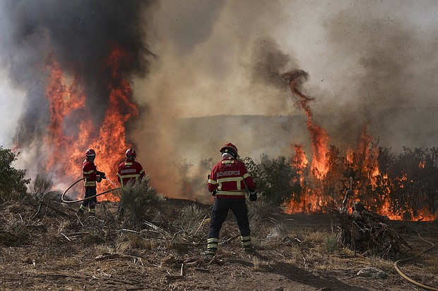 Firefighters battle a wildfire in Trancoso, Portugal, on August 11.
Mandatory Credit:	Patricia de Melo Moreira/AFP/Getty Images via CNN Newsource