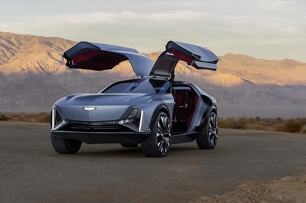 Front 3/4 view of the Cadillac Elevated Velocity concept in Vapor Blue with the gull-wing doors open with the desert in the background.